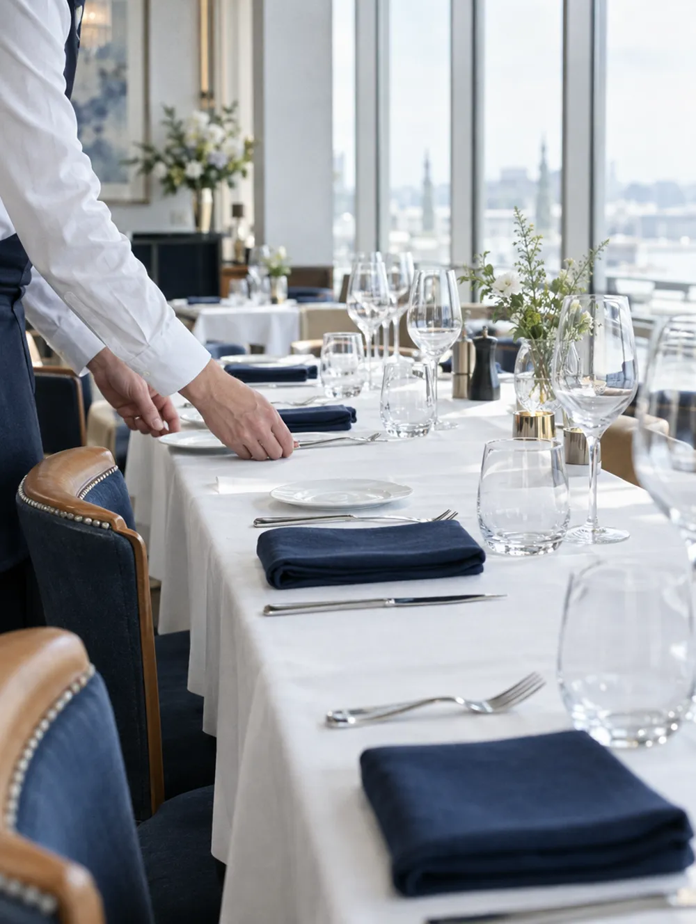 Hotel restaurant before service, a hand setting a place