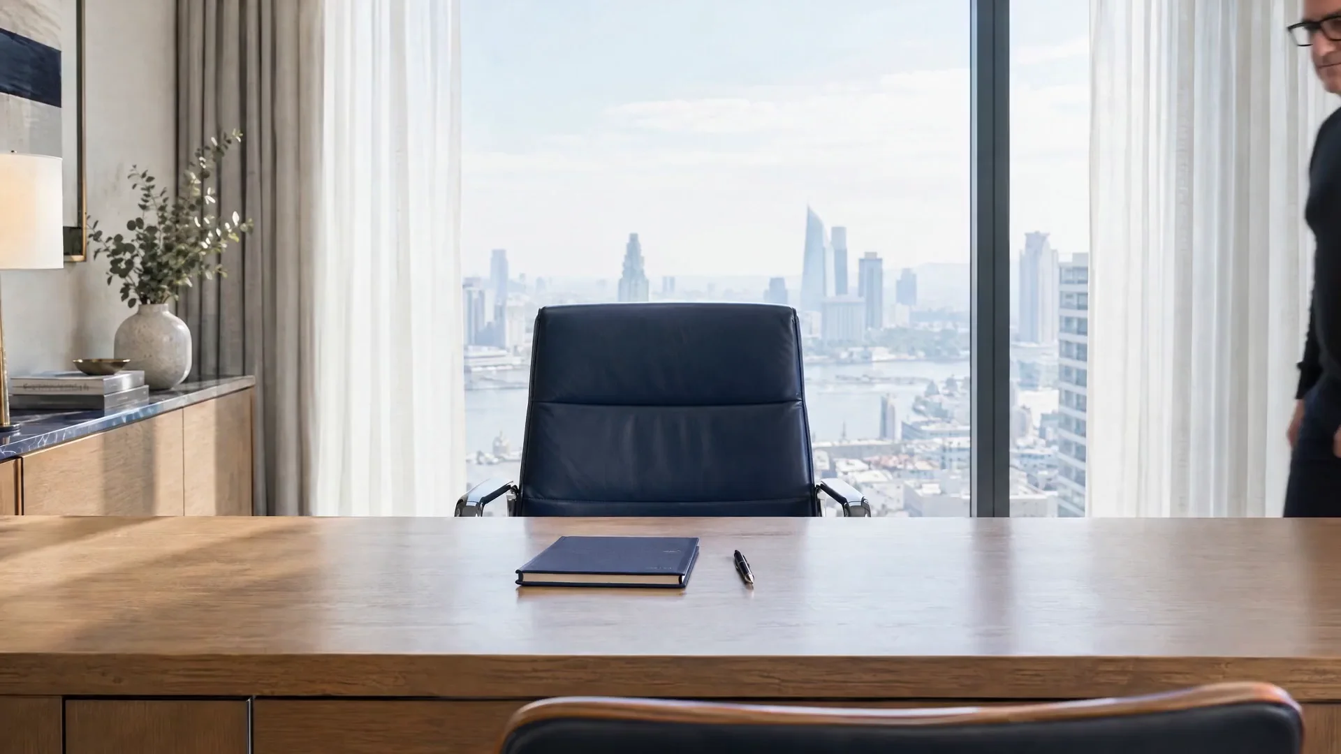 Bright office with an empty desk and a navy notebook